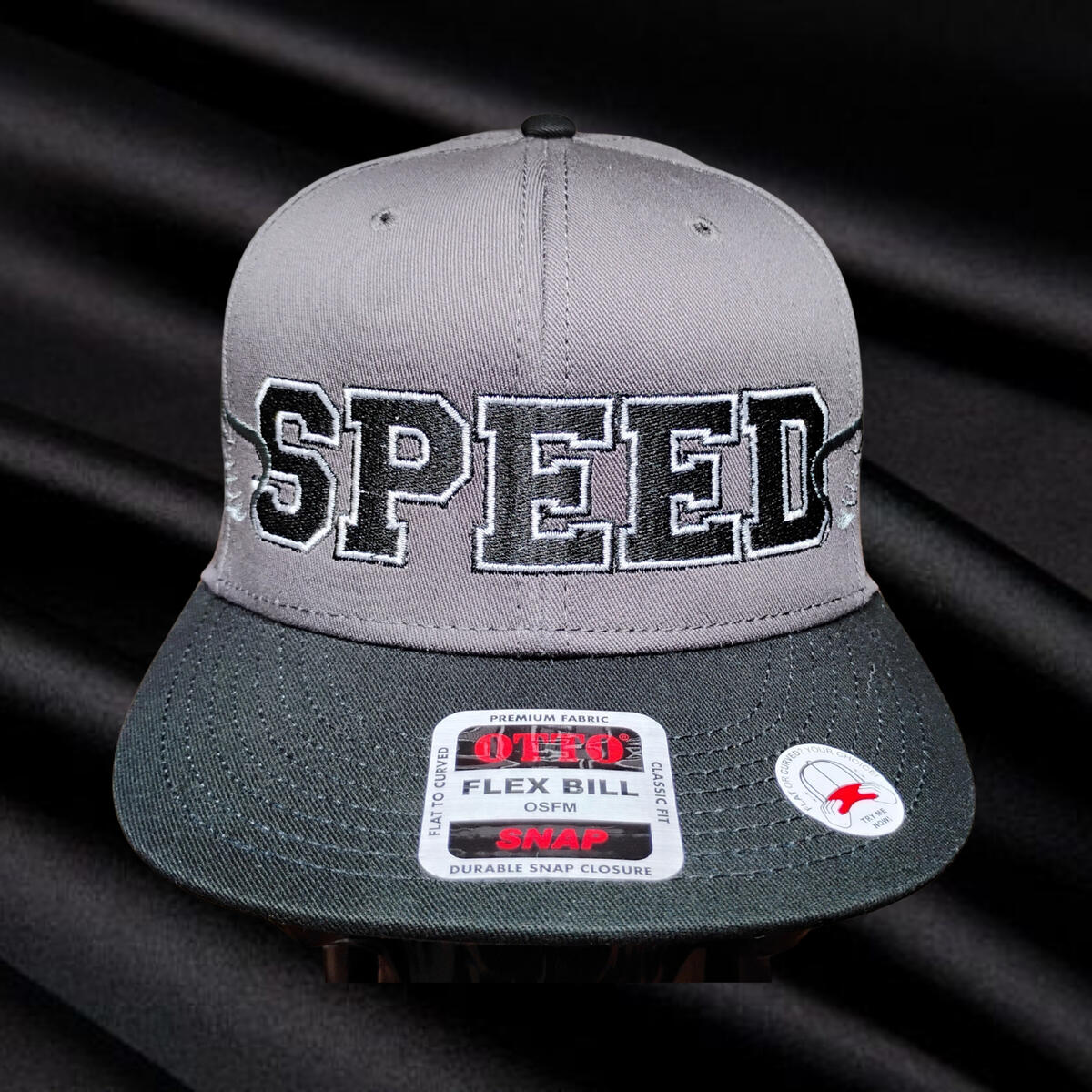 The Speed Wings hat. Bold varsity-style lettering. Two-color embroidery. Angled wings that stretch across the crown and wrap toward the sides. This design pulls from old race jackets, team gear, and era-correct motorsports graphics