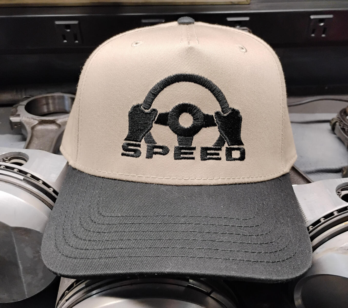 The Apex – Natural Snapback There’s a moment in every corner where everything tightens. Grip. Focus. Commitment. The Apex captures that split second — embroidered with gloved hands locked onto the wheel, honoring the driver’s mindset. Calm. Precise.